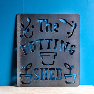 the potting shed metal sign