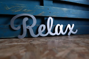 relax metal word sign